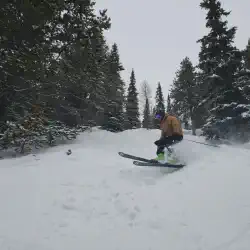 Alex skiing Ptarmigan Glades off the Ptarmigan chain at Lake Louise.