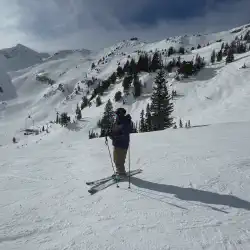 Alex standing up looking down the mountain at Snowbird